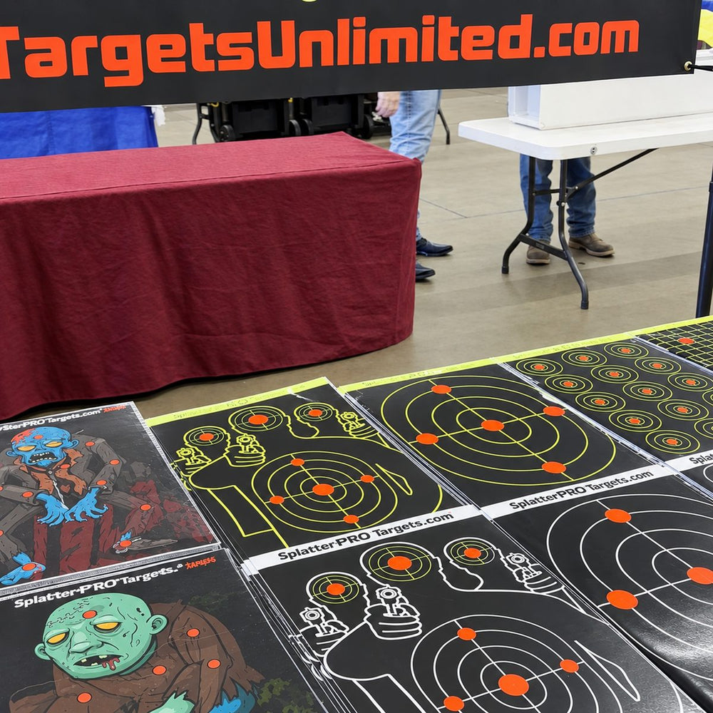 Stacks of splatter target packs on a table: zombie, silhouette and bullseye designs