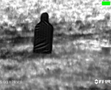 ESP thermal sleeve target seen through a FLIR thermal camera, dark silhouette against the field