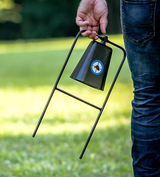 Do-All Outdoors .22 cow bell target carried by hand across a lawn — image 3