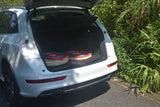 Traditional straw targets stacked flat in the open trunk of an SUV — image 5